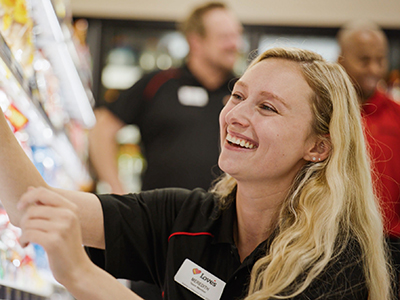 A photo of an employee restocking shelves