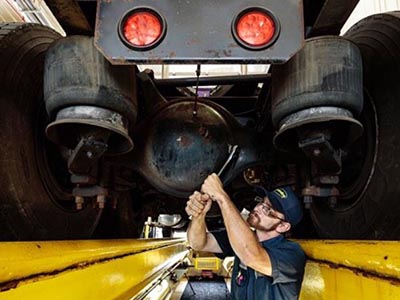 speedco mechanic working on truck