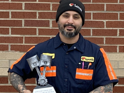 Cameron poses with one of his many trophies. 